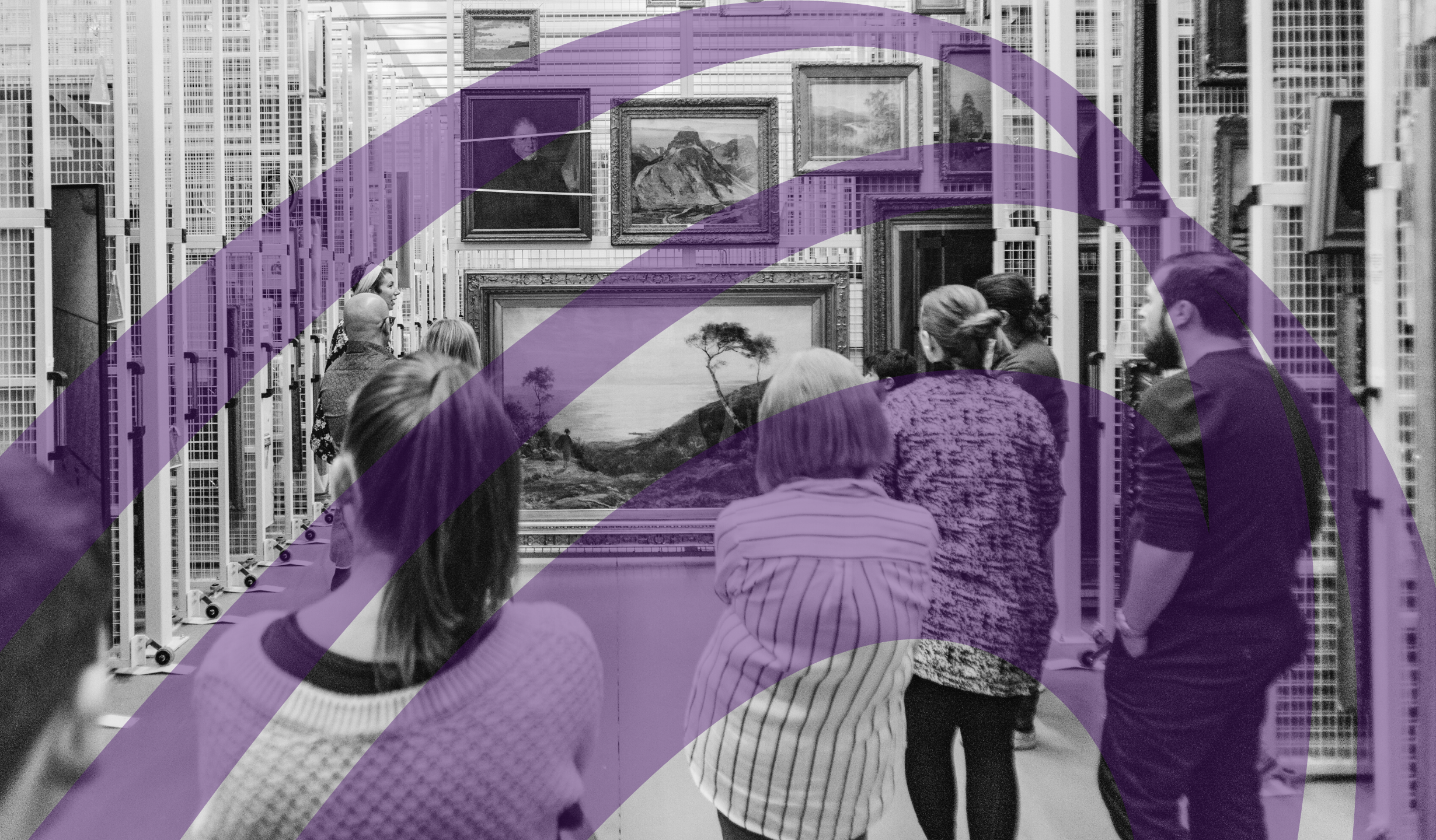 Black and white image of an older white man standing in front of a glass museum reception desk. The desk frontage says "Fairfield Heritage"